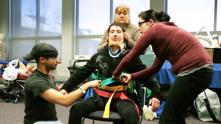 Students engage in hands-on learning in an EMT class.