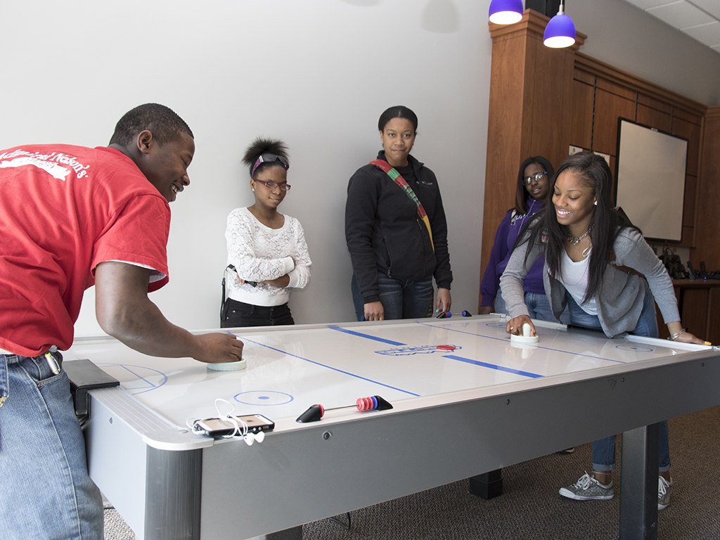 Students enjoying the Hawk's Nest, Heartland's student recreation room on the Normal campus.